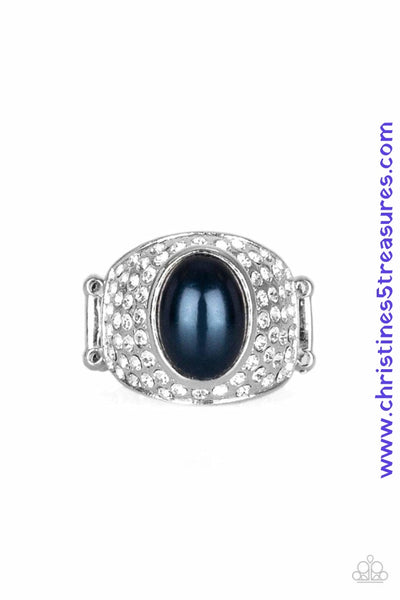 A pearly blue bead is pressed into the center of a bold silver band radiating with countless white rhinestones, creating a dramatic statement piece atop the finger. Features a stretchy band for a flexible fit. Sold as one individual ring.  P4RE-BLXX-160XX