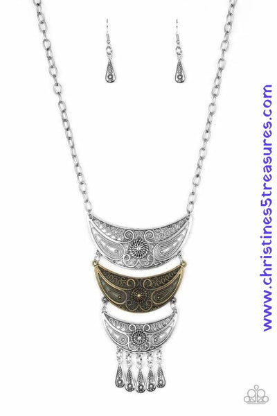 Gradually decreasing in size down the chest, decorative silver and brass crescent plates connect into a bold pendant. Dotted in dainty studs, teardrop silver frames swing from the bottom of the tribal inspired pendant for a fierce finish. Features an adjustable clasp closure. Sold as one individual necklace. Includes one pair of matching earrings.   P2TR-MTXX-056XX
