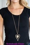Hammered in glistening texture, mismatched gold heart frames swing from the bottom of a lengthened gold chain for a whimsical look. Features an adjustable clasp closure. Sold as one individual necklace. Includes one pair of matching earrings.  P2WH-GDXX-153XX
