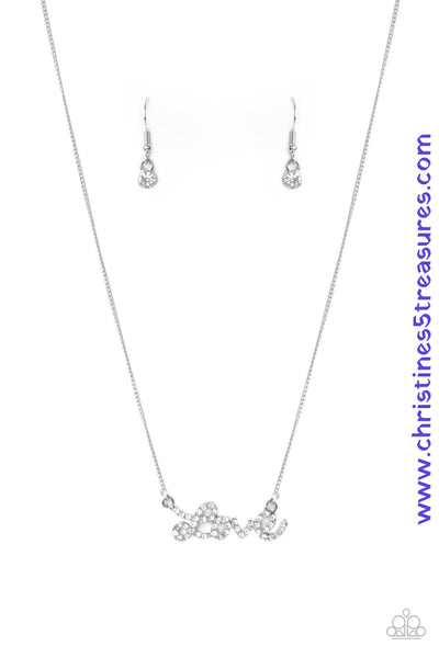 Encrusted in glassy white rhinestones, the word, "love," connects to a dainty silver chain, creating a flirty pendant below the collar. Features an adjustable clasp closure. Sold as one individual necklace. Includes one pair of matching earrings. P2RE-WTXX-504XX