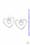 A dainty white rhinestone encrusted heart frame swings from the top of an oversized silver heart frame, creating a charming duo. Earring attaches to a standard fishhook fitting. Sold as one pair of earrings. P5RE-WTXX-445XX