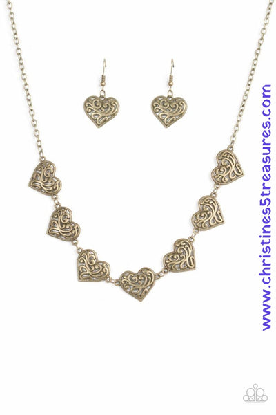 Featuring filigree-filled centers, glistening brass heart frames connect below the collar in a romantic fashion. Features an adjustable clasp closure. Sold as one individual necklace. Includes one pair of matching earrings.  P2WH-BRXX-120VI