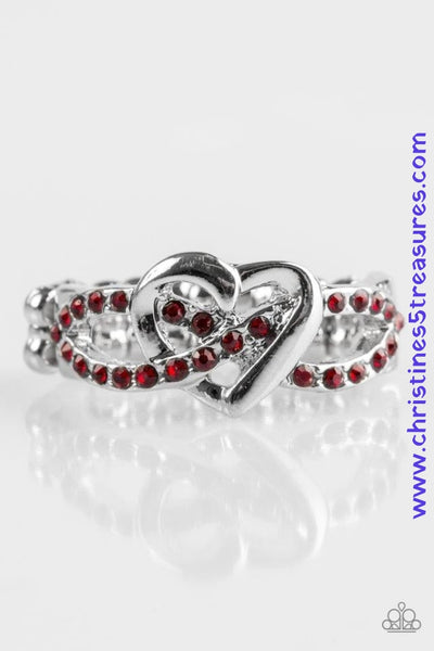 Encrusted in glittery red rhinestones, silver ribbons crisscross across the finger, creating a dainty band. A glistening silver heart adorns the center of the band for a romantic finish. Features a dainty stretchy band for a flexible fit.  P4RE-RDXX-073XX