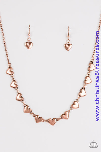 Brushed in a bright shimmer, dainty shiny copper heart frames link below the collar in a timeless fashion. Features an adjustable clasp closure. Sold as one individual necklace. Includes one pair of matching earrings.  P2WH-CPSH-112XX