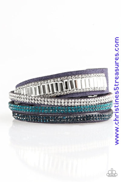 Encrusted in mismatched sparkle, half of a blue suede band is encrusted in white emerald style cut rhinestones, while the other half splits into three separate bands encrusted in white and blue rhinestones for a sassy look. The elongated band allows for a trendy double wrap design. Features an adjustable snap closure. Sold as one individual bracelet.  P9DI-URBL-042XX