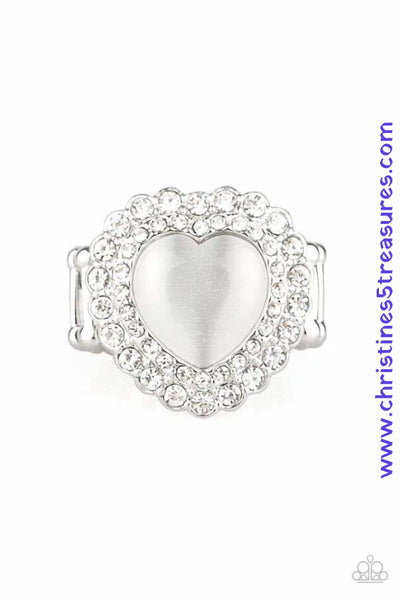 Chiseled into a charming heart shape, a glowing white cat's eye stone is pressed into the center of two silver heart frames radiating with glassy white rhinestones, creating a sparkling centerpiece atop the finger. Features a stretchy band for a flexible fit. Sold as one individual ring. P4RE-WTXX-369XX