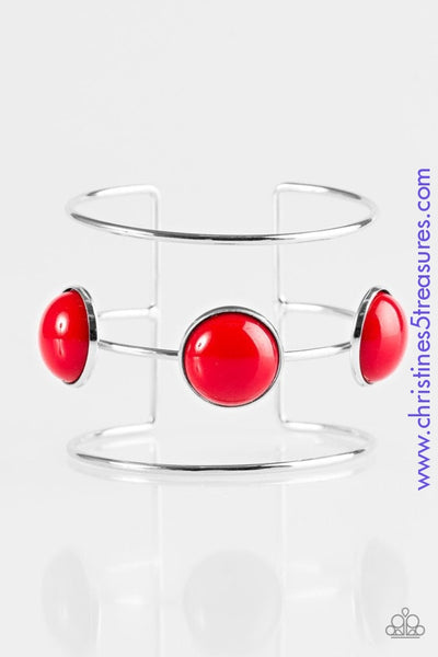 Three shimmery silver bars arc across the wrist, coalescing into an airy cuff. Three fiery red beads are pressed into the centermost bar for a bubbly finish.  P9ED-RDXX-020XX