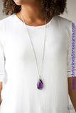 A dramatically oversized purple gem and edgy silver frame swing from a glassy white rhinestone fitting at the bottom of a lengthened silver chain for a glamorous look. Features an adjustable clasp closure. Sold as one individual necklace. Includes one pair of matching earrings.  P2RE-PRXX-181XX