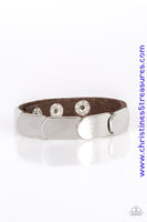 Overlapping silver frames are studded in place across a skinny brown leather band for a rugged look Features an adjustable snap closure. Sold as one individual bracelet.  P9UR-BNXX-395XX