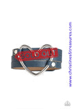 An oversized silver heart frame is studded in place across the center of a spliced blue leather band for a seasonal look. Features an adjustable snap closure. Sold as one individual bracelet.  P9UR-BLXX-146XX