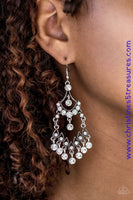 Glittery white rhinestones are sprinkled along stacked silver frames, creating an elegant lure. Matching white rhinestones swing from the bottom of the elaborate lure, adding a glamorous finish to the regal palette. Earring attaches to a standard fishhook fitting. Sold as one pair of earrings.  P5RE-WTXX-312XX