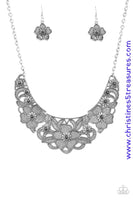 Featuring lattice-like patterns, shimmery silver flowers bloom below the collar for a seasonal look. Features an adjustable clasp closure. Sold as one individual necklace. Includes one pair of matching earrings.   P2ED-SVXX-119XX