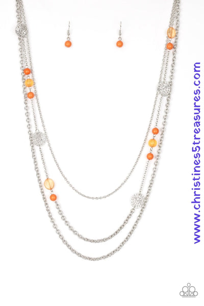 Ornate silver accents, glassy beads, and polished orange beads trickle along strands of shimmery silver chains for a whimsical look. Features an adjustable clasp closure. Sold as one individual necklace. Includes one pair of matching earrings.  P2WH-OGXX-188XX