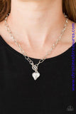 Cut into a whimsical heart shape, a glittery white gem swings from the bottom of a glistening silver chain below the collar for a charming look. Features a toggle closure. Sold as one individual necklace. Includes one pair of matching earrings.  P2WH-WTXX-222XX