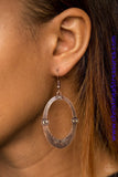 Etched in circular textures, a shimmery copper oval is encrusted in dainty topaz frames for an edgy look. Earring attaches to a standard fishhook fitting. Sold as one pair of earrings.  P5TR-CPXX-077XX