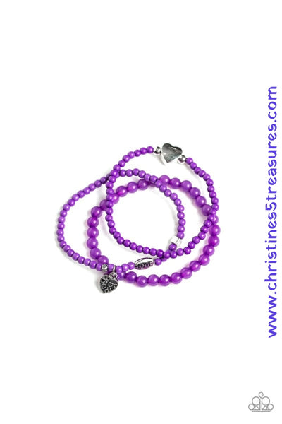 An array of glassy and polished purple beads are threaded along stretchy bands. Infused with silver accents, a collection of silver heart charms and a bead spelling out the word, "love", adorn the beaded strands for a romantic finish. Sold as one set of three bracelets.  P9WH-PRXX-171XX