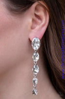 2019 Empower Me Pink Gradually decreasing in size, glittery white gems trickle from the ear in a glamorous fashion. Earring attaches to a standard post fitting. Sold as one pair of post earrings. P5PO-WTXX-170XX