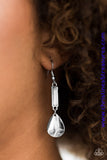 Chiseled into a rectangle, an earthy white stone is pressed into a sleek silver frame. A shimmery silver teardrop swings from the bottom of the stone frame, creating a seasonal lure. Earring attaches to a standard fishhook fitting. Sold as one pair of earrings.  P5SE-WTXX-070XX