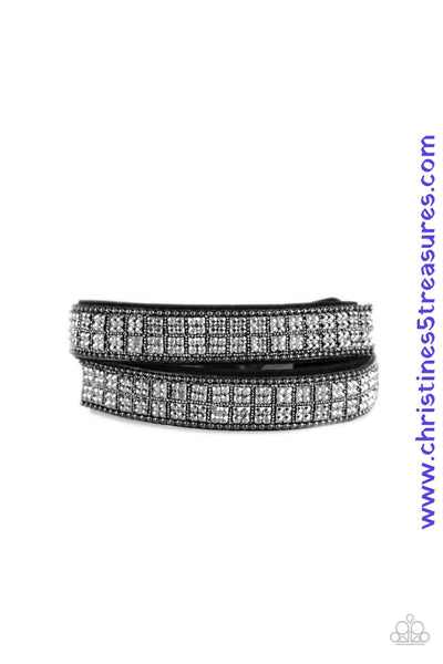 Infused with dainty gunmetal ball chain, glittery hematite rhinestones are sprinkled across a black suede band in a cube like pattern for an edgy look. The elongated band allows for a trendy double wrap design. Features an adjustable snap closure. Sold as one individual bracelet.  P9DI-URBK-172XX