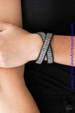 Infused with dainty gunmetal ball chain, glittery hematite rhinestones are sprinkled across a black suede band in a cube like pattern for an edgy look. The elongated band allows for a trendy double wrap design. Features an adjustable snap closure. Sold as one individual bracelet.  P9DI-URBK-172XX