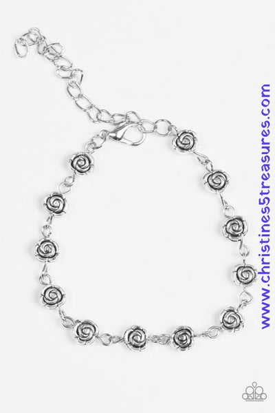 Dainty silver rosebuds link around the wrist, creating a beautiful feminine palette. Features an adjustable clasp closure. Sold as one individual bracelet.   Get The Complete Look! Necklace: “Roadside Roses – Silver” (Sold Separately)  P9DA-SVXX-144RT