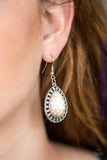 Chiseled into a tranquil teardrop, a refreshing white stone is pressed into a shimmery silver frame radiating with tribal inspired textures for a seasonal look. Earring attaches to a standard fishhook fitting. Sold as one pair of earrings. P5SE-WTXX-086XX