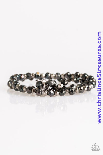 Brushed in a metallic sheen, glittery black crystal-like beads and faceted silver beads are threaded along stretchy elastic bands. Matching beads swing from the wrist, creating clustered centerpieces. Sold as one set of two bracelets.  P9RE-BKXX-185WK