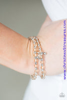 Brushed in a metallic sheen, glittery brown crystal-like beads and faceted silver beads are threaded along stretchy elastic bands. Matching beads swing from the wrist, creating clustered centerpieces. Sold as one set of two bracelets.  P9RE-BNXX-085SO