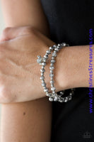 Hematite and smoky crystal-like beads and faceted silver beads are threaded along stretchy elastic bands. Matching gunmetal beads swing from the wrist, creating clustered centerpieces. Sold as one set of two bracelets.  P9RE-SVXX-188GR