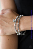 Hematite and smoky crystal-like beads and faceted silver beads are threaded along stretchy elastic bands. Matching gunmetal beads swing from the wrist, creating clustered centerpieces. Sold as one set of two bracelets.  P9RE-SVXX-188GR