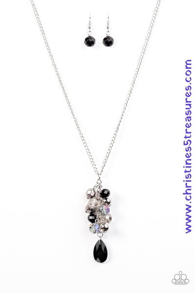 Faceted black, gunmetal, and iridescent crystal beads trickle from the bottom of a lengthened silver chain, creating a clustered pendant. Infused with classic silver beads, a faceted black teardrop swings from the bottom of the glittery pendant for a whimsical finish. Features an adjustable clasp closure. Sold as one individual necklace. Includes one pair of matching earrings.  P2WH-BKXX-162XX
