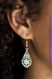 Glittery white rhinestones are sprinkled across a dainty floral frame, creating a whimsical lure. Earring attaches to a standard fishhook fitting. Sold as one pair of earrings.  P5RE-GDRS-150XX