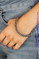 Bedazzled in glittery hematite rhinestones, a bendable cuff-like bracelet delicately curls around the wrist for a refined look. Sold as one individual bracelet.  P9RE-BKXX-273XX