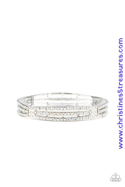 Sporadically dotted in rows of iridescent rhinestones and shiny silver studs, stacked silver frames are threaded along a stretchy band around the wrist for a refined look. Sold as one individual bracelet.  P9RE-MTXX-060XX