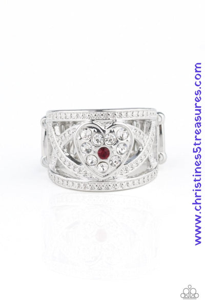Dotted in dainty silver studs, glistening silver bands weave across the finger. A white rhinestone encrusted silver heart adorns the center, creating a flirtatious centerpiece. A dainty red rhinestone dots the center for a colorful finish. Features a stretchy band for a flexible fit. Sold as one individual ring.  P4RE-RDXX-125XX