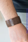 Featuring a slitted center, a band of brown leather wraps around the wrist for an urban look. Features an adjustable snap closure. Sold as one individual bracelet.  P9UR-BNXX-328XX