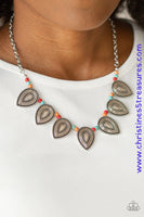A collection of dainty multicolored stone beads and ornate silver teardrop frames are threaded along an invisible wire below the collar for a fierce tribal look. Features an adjustable clasp closure. Sold as one individual necklace. Includes one pair of matching earrings.  P2SE-MTXX-183XX