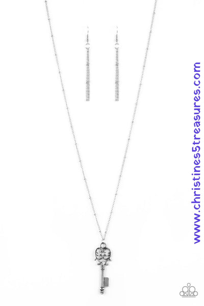 An ornate silver key pendant swings from the bottom of a lengthened silver satellite chain for a vintage inspired look. Features an adjustable clasp closure. Sold as one individual necklace. Includes one pair of matching earrings.  P2DA-SVXX-201XX