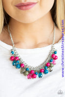 Varying in shape, glassy and polished blue, green, and pink beads swing from the bottom of interlocking silver chains. Crystal-like teardrops are sprinkled along the colorful beading, creating a flirtatious fringe below the collar. Features an adjustable clasp closure. Sold as one individual necklace. Includes one pair of matching earrings.  P2WH-MTXX-199XX