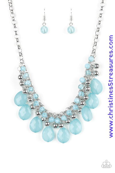 A row of cloudy blue beads gives way to a row of shiny silver beads. Brushed in an opalescent finish, blue teardrops cascade from the bottom of bold interlocking silver chains, creating a dramatically colorful fringe. Features an adjustable clasp closure. Sold as one individual necklace. Includes one pair of matching earrings.  P2ED-BLXX-037XX