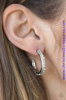 Encrusted in dazzling white rhinestones, a studded silver hoop swings from the ear for a glamorous look. Earring attaches to a standard post fitting. Hoop measures 1" in diameter. Sold as one pair of hoop earrings. P5HO-WTXX-041XX