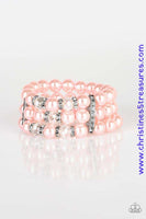 Pinched between white rhinestone encrusted frames, white rhinestone encrusted rings, crystal-beads, and pink pearls are threaded along elastic stretchy bands for a glamorous look. Sold as one individual bracelet.  P9RE-PKXX-128XX