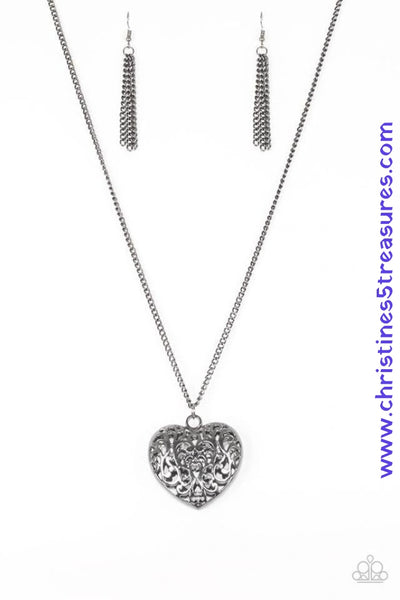 Vine-like filigree climbs the front and back of a heart-shaped pendant, creating a dramatic 3-dimensional pendant. The vintage inspired pendant swings from the bottom of a lengthened gunmetal chain for a gorgeous tone on tone finish. Features an adjustable clasp closure. Sold as one individual necklace. Includes one pair of matching earrings.   P2WH-BKXX-228XX