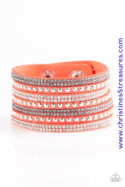 Shiny silver studs and rows of smoky and glittery white rhinestones are encrusted along strips of orange suede, creating sassy shimmer around the wrist. Features an adjustable snap closure. Sold as one individual bracelet.  P9DI-UROG-025XX