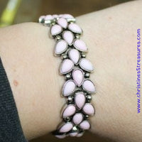 Faceted pink teardrop beads and shimmery silver studs coalesce into ornate frames. The whimsical frames are threaded along stretchy bands around the wrist for a seasonal look. Sold as one individual bracelet.  P9WH-PKXX-215XX