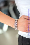 Faceted pink teardrop beads and shimmery silver studs coalesce into ornate frames. The whimsical frames are threaded along stretchy bands around the wrist for a seasonal look. Sold as one individual bracelet.  P9WH-PKXX-215XX