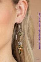 A tranquil collection of glassy green and brown crystal-like beads dangle from a dainty silver hoop, creating a whimsical lure. Earring attaches to a standard fishhook fitting. Sold as one pair of earrings.  P5WH-MTXX-158XX