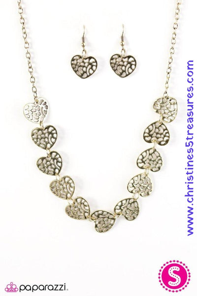 Airy brass heart frames link below the collar, creating a whimsical chain. Brushed in an antiqued finish, the stenciled hearts are delicately hammered for a shimmery finish. Features an adjustable clasp closure. Sold as one individual necklace. Includes one pair of matching earrings.   P2WH-BRXX-080XX