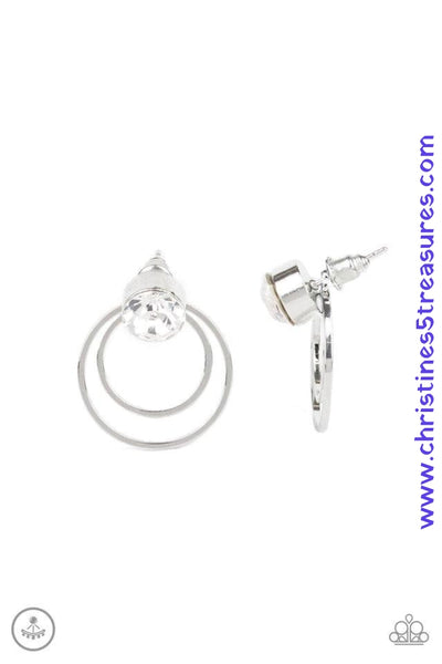 A solitaire white rhinestone attaches to a double-sided post, designed to fasten behind the ear. Brushed in a high-sheen silver finish, the circular double sided-post peeks out beneath the ear for a refined finish. Earring attaches to a standard post fitting. Sold as one pair of double-sided post earrings.  P5PO-WTXX-214XX
